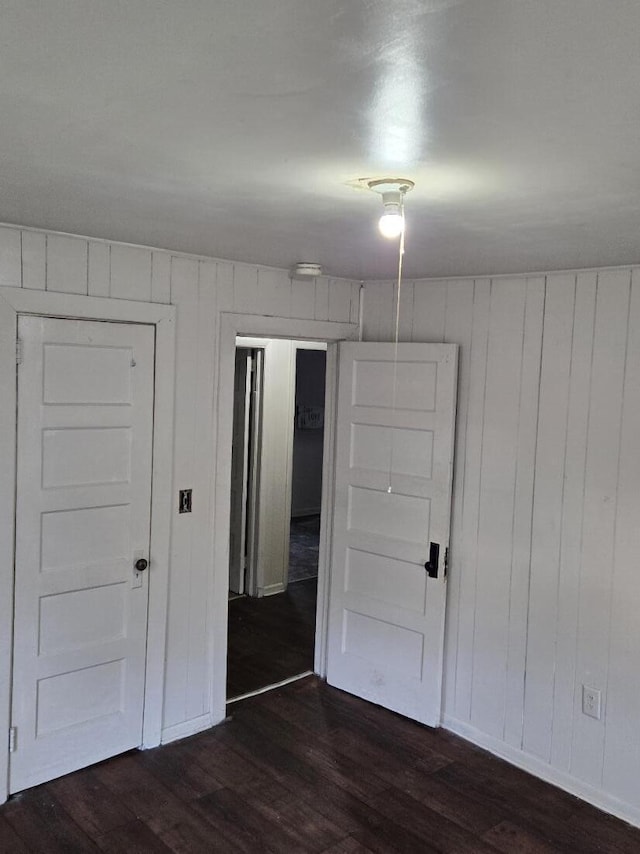 213 Whitehead St, Thomson, GA 30824 - unfurnished room with dark wood-style floors, baseboards, and wooden walls