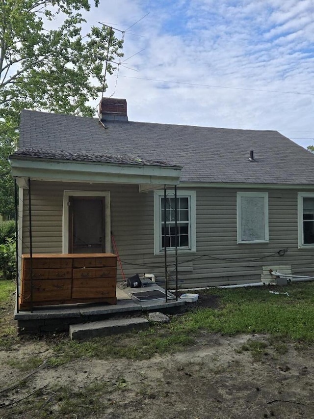 213 Whitehead St, Thomson, GA 30824 - back of house featuring a chimney and roof with shingles