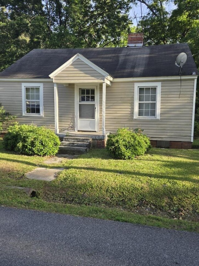 213 Whitehead St, Thomson, GA 30824 - view of front of property with a front yard, roof with shingles, a chimney, and entry steps
