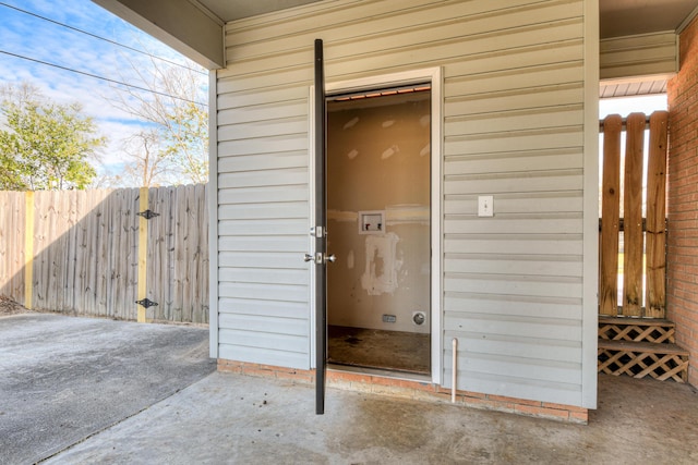 entrance to property featuring fence