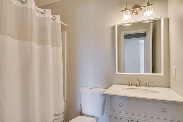 full bath with curtained shower, vanity, and toilet