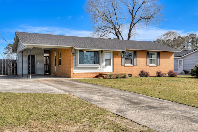 ranch-style house with concrete driveway, brick siding, a front lawn, and fence