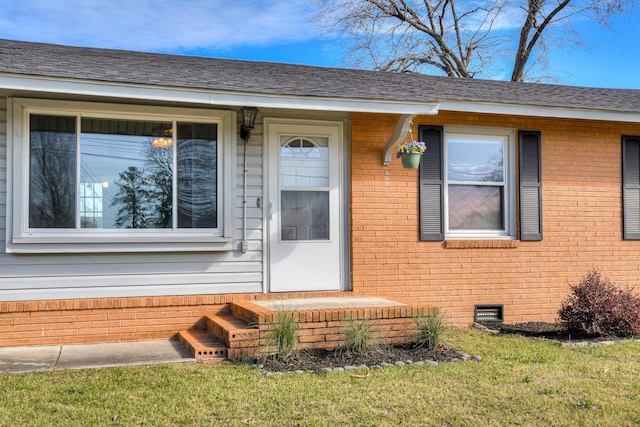 property entrance featuring brick siding, crawl space, and a shingled roof