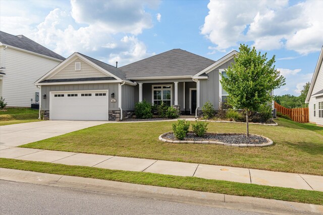 751 Bancroft Dr, Grovetown, GA 30813 - craftsman-style home with board and batten siding, an attached garage, concrete driveway, and stone siding