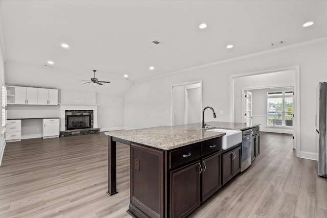 751 Bancroft Dr, Grovetown, GA 30813 - kitchen featuring ceiling fan, a stone fireplace, a center island with sink, light wood finished floors, and recessed lighting