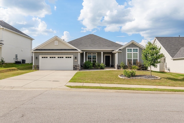 751 Bancroft Dr, Grovetown, GA 30813 - craftsman house featuring board and batten siding, a garage, driveway, a front lawn, and stone siding