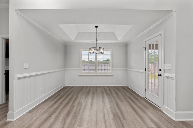 751 Bancroft Dr, Grovetown, GA 30813 - unfurnished dining area featuring light wood-style floors, a raised ceiling, wainscoting, a chandelier, and crown molding