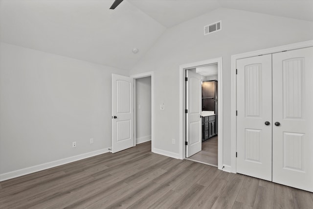 751 Bancroft Dr, Grovetown, GA 30813 - unfurnished bedroom featuring lofted ceiling, wood finished floors, a closet, connected bathroom, and a ceiling fan