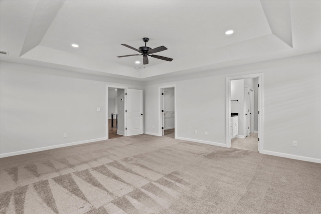 751 Bancroft Dr, Grovetown, GA 30813 - unfurnished bedroom with a tray ceiling, light carpet, a walk in closet, recessed lighting, and ensuite bath