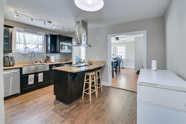 501 Beaufort Dr, Augusta, GA 30904 - kitchen with appliances with stainless steel finishes, dark cabinets, a breakfast bar area, and ceiling fan