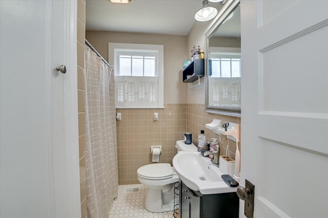 501 Beaufort Dr, Augusta, GA 30904 - full bathroom featuring vanity, tile patterned flooring, tile walls, curtained shower, and wainscoting