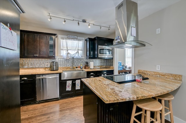 501 Beaufort Dr, Augusta, GA 30904 - kitchen with stainless steel appliances, island exhaust hood, a peninsula, a breakfast bar, and backsplash