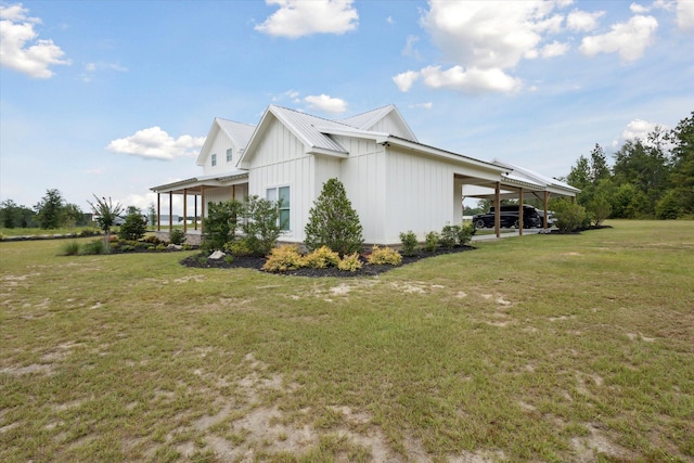 1513 Paris Ave, Swainsboro, GA 30401 - view of side of property featuring a yard, board and batten siding, and a metal roof