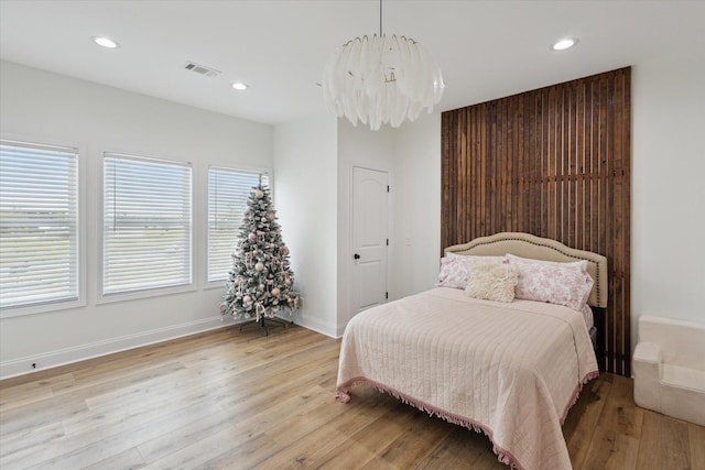 1513 Paris Ave, Swainsboro, GA 30401 - bedroom with light wood-style flooring, recessed lighting, and a chandelier