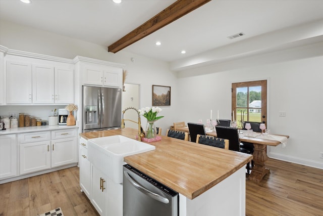 1513 Paris Ave, Swainsboro, GA 30401 - kitchen featuring stainless steel appliances, beam ceiling, light wood-style floors, recessed lighting, and white cabinets