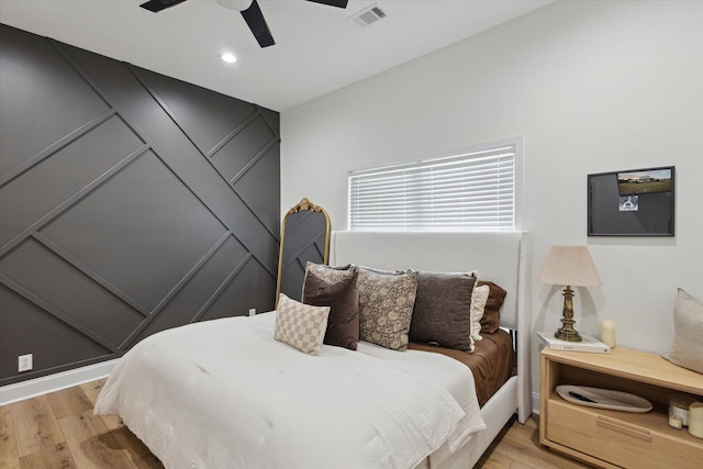 1513 Paris Ave, Swainsboro, GA 30401 - bedroom with light wood finished floors, ceiling fan, recessed lighting, and a decorative wall