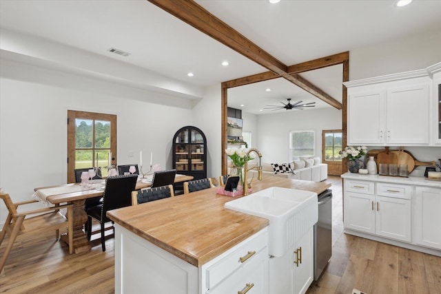 1513 Paris Ave, Swainsboro, GA 30401 - kitchen with recessed lighting, open floor plan, beam ceiling, light wood-type flooring, and white cabinets
