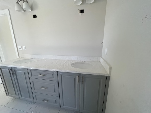 bathroom featuring marble finish floor and vanity