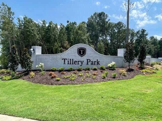 community / neighborhood sign with a lawn