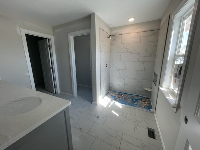 full bath featuring marble finish floor, a stall shower, vanity, and baseboards