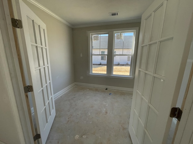 interior space with baseboards, unfinished concrete floors, visible vents, and crown molding