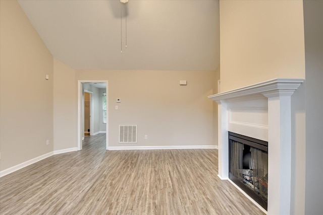 1907 Lobelia Ln, Augusta, GA 30906 - unfurnished living room featuring wood finished floors, a fireplace, lofted ceiling, and baseboards