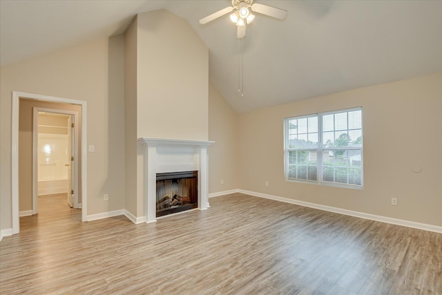 1907 Lobelia Ln, Augusta, GA 30906 - unfurnished living room featuring a ceiling fan, light wood-type flooring, vaulted ceiling, a fireplace, and baseboards