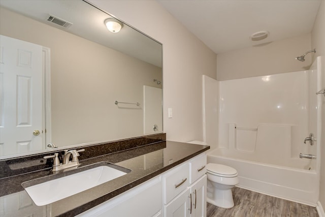 1907 Lobelia Ln, Augusta, GA 30906 - bathroom with toilet, wood finished floors,  shower combination, and vanity