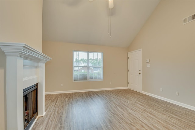 1907 Lobelia Ln, Augusta, GA 30906 - unfurnished living room with wood finished floors, a fireplace, a ceiling fan, baseboards, and high vaulted ceiling