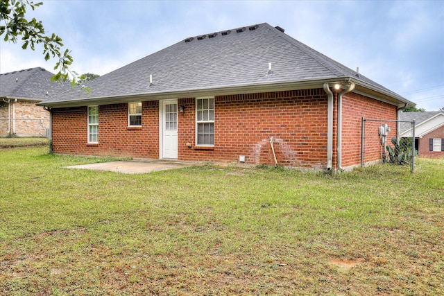 1907 Lobelia Ln, Augusta, GA 30906 - rear view of house featuring a patio area, brick siding, a shingled roof, and a yard