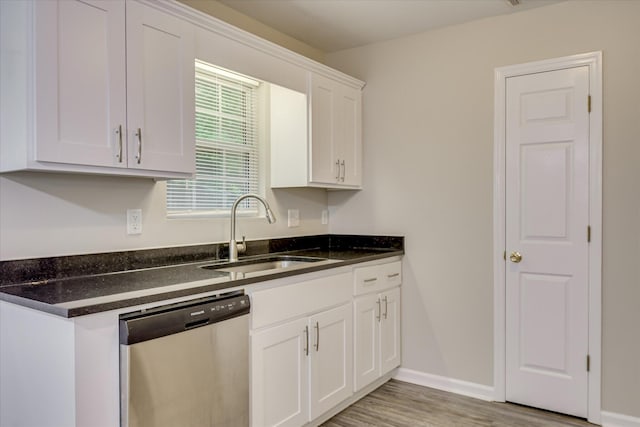 1907 Lobelia Ln, Augusta, GA 30906 - kitchen featuring stainless steel dishwasher, a sink, white cabinetry, light wood-style floors, and baseboards