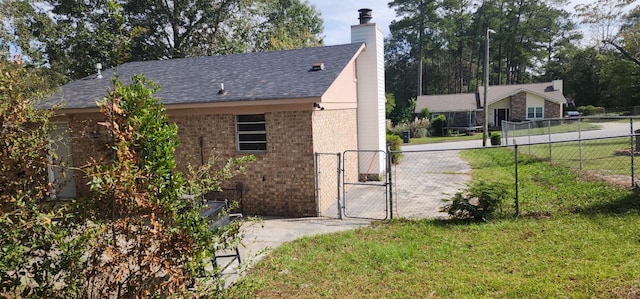 3545 Monte Carlo Dr, Augusta, GA 30906 - view of home's exterior with a gate, brick siding, a chimney, and roof with shingles