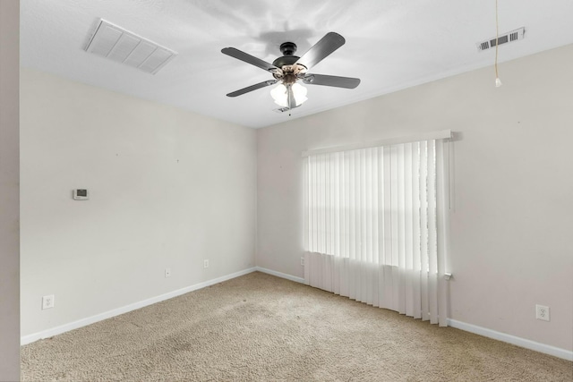 spare room featuring ceiling fan and light carpet