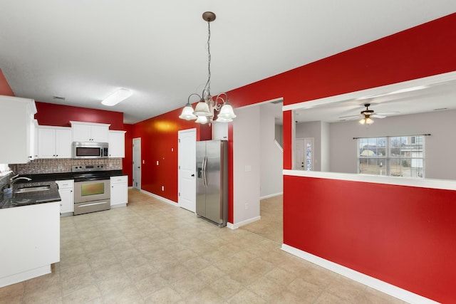 kitchen with sink, white cabinetry, ceiling fan with notable chandelier, hanging light fixtures, and appliances with stainless steel finishes