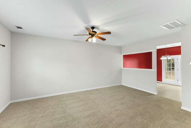 carpeted empty room with ceiling fan with notable chandelier