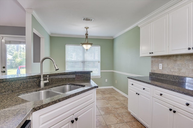 4506 Marthas Way, Grovetown, GA 30813 - kitchen featuring decorative backsplash, white cabinetry, dark stone countertops, decorative light fixtures, and crown molding