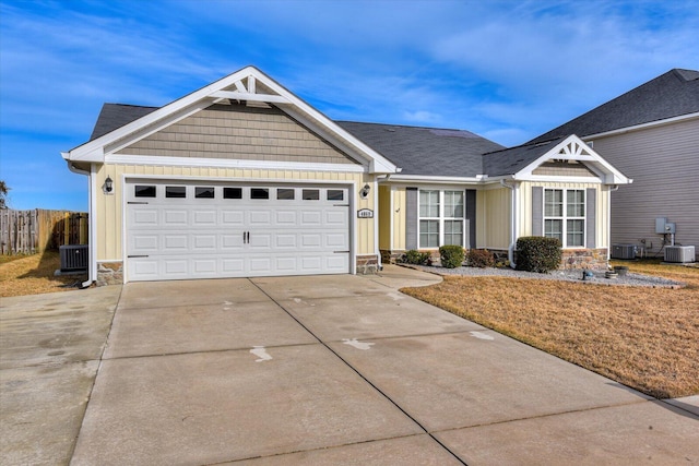 view of front of home featuring a garage and central AC