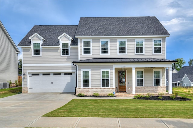 635 River Oaks Ln, Evans, GA 30809 - view of front of house featuring a standing seam roof, brick siding, a porch, and concrete driveway
