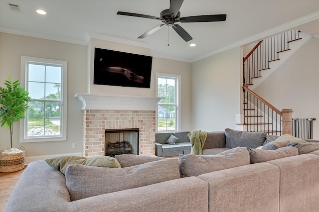 635 River Oaks Ln, Evans, GA 30809 - living room featuring crown molding, stairway, ceiling fan, wood finished floors, and a brick fireplace