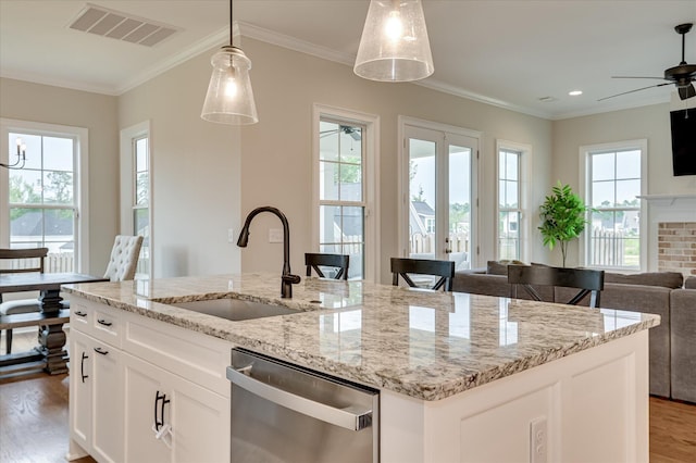 635 River Oaks Ln, Evans, GA 30809 - kitchen with stainless steel dishwasher, open floor plan, wood finished floors, ceiling fan, and hanging light fixtures