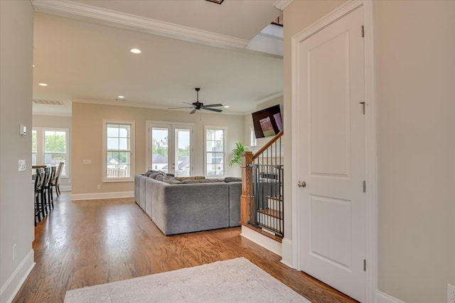 635 River Oaks Ln, Evans, GA 30809 - living area with crown molding, wood finished floors, ceiling fan, recessed lighting, and stairway
