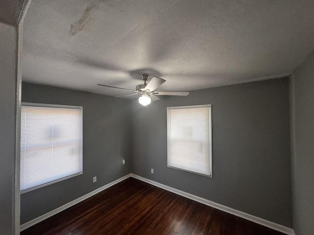 unfurnished room with a textured ceiling, dark hardwood / wood-style floors, and ceiling fan