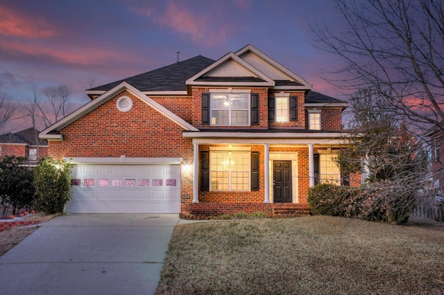 view of front of home with a garage and a lawn