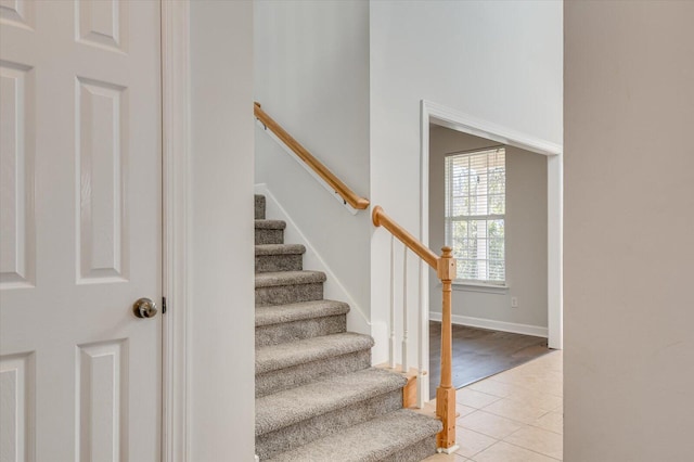 stairway featuring tile patterned floors