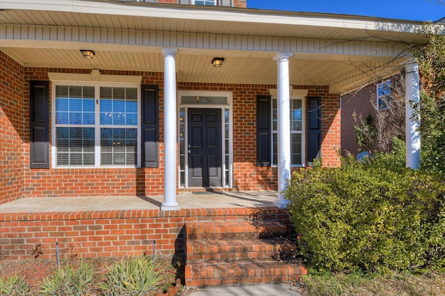 view of exterior entry with a porch