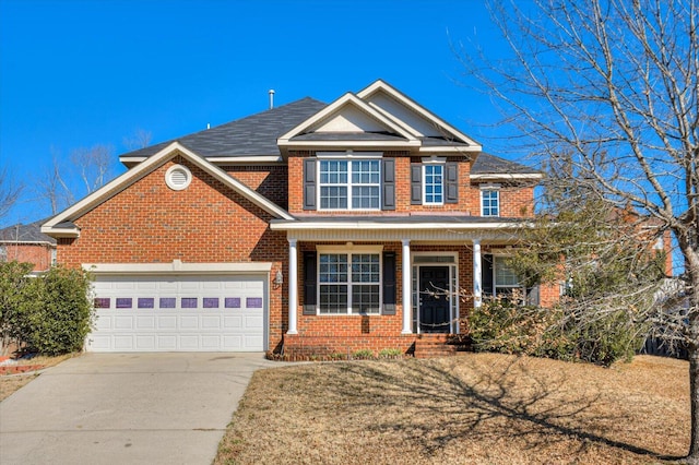 view of front of home with a front lawn and a garage