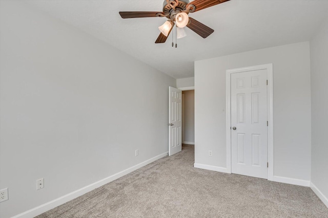 unfurnished bedroom featuring ceiling fan and light carpet