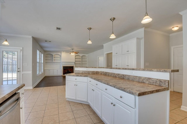 kitchen featuring pendant lighting, light tile patterned floors, white cabinetry, and stainless steel dishwasher