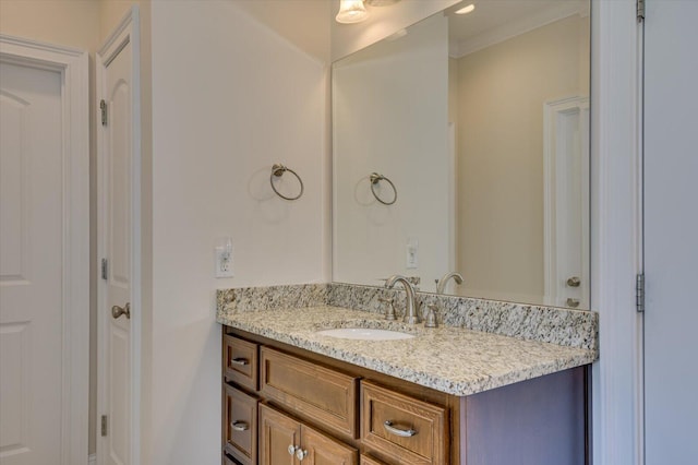 bathroom with vanity and ornamental molding