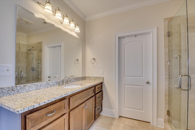 bathroom with vanity, tile patterned floors, a shower with door, and ornamental molding